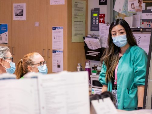 Three nurses having a discussion.